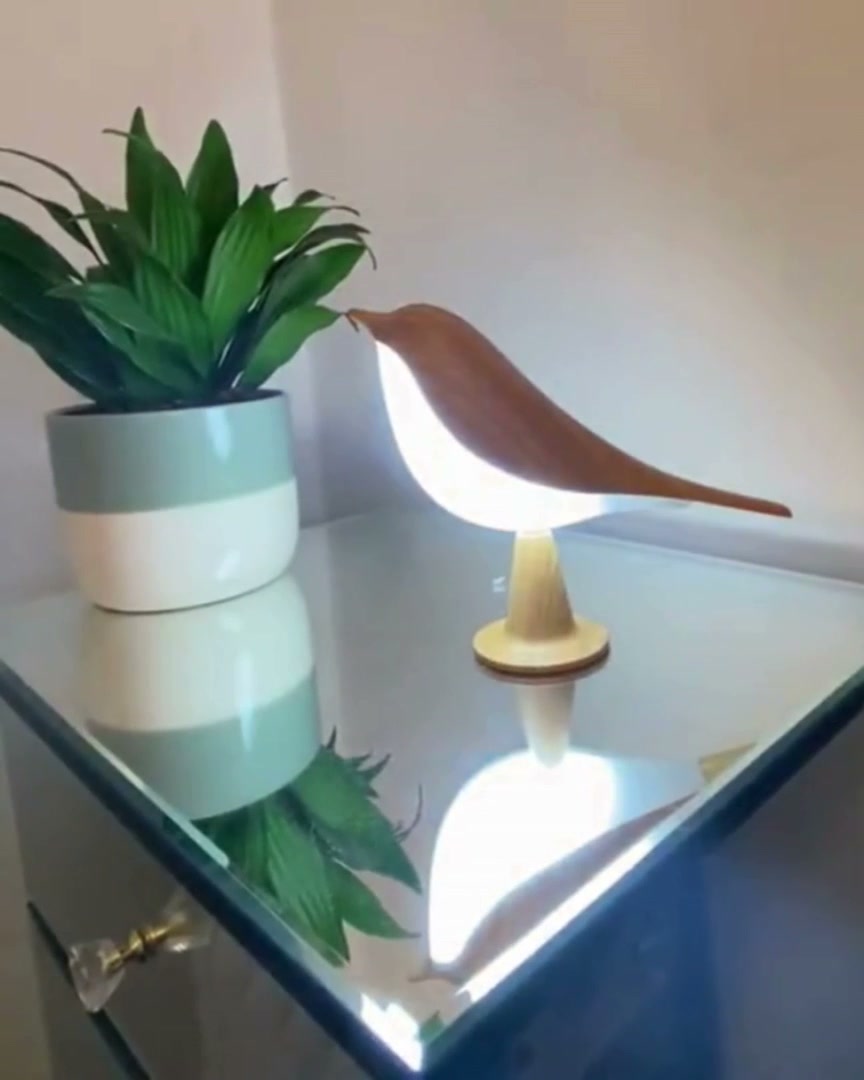 Bird lamp on a mirrored chest of drawers