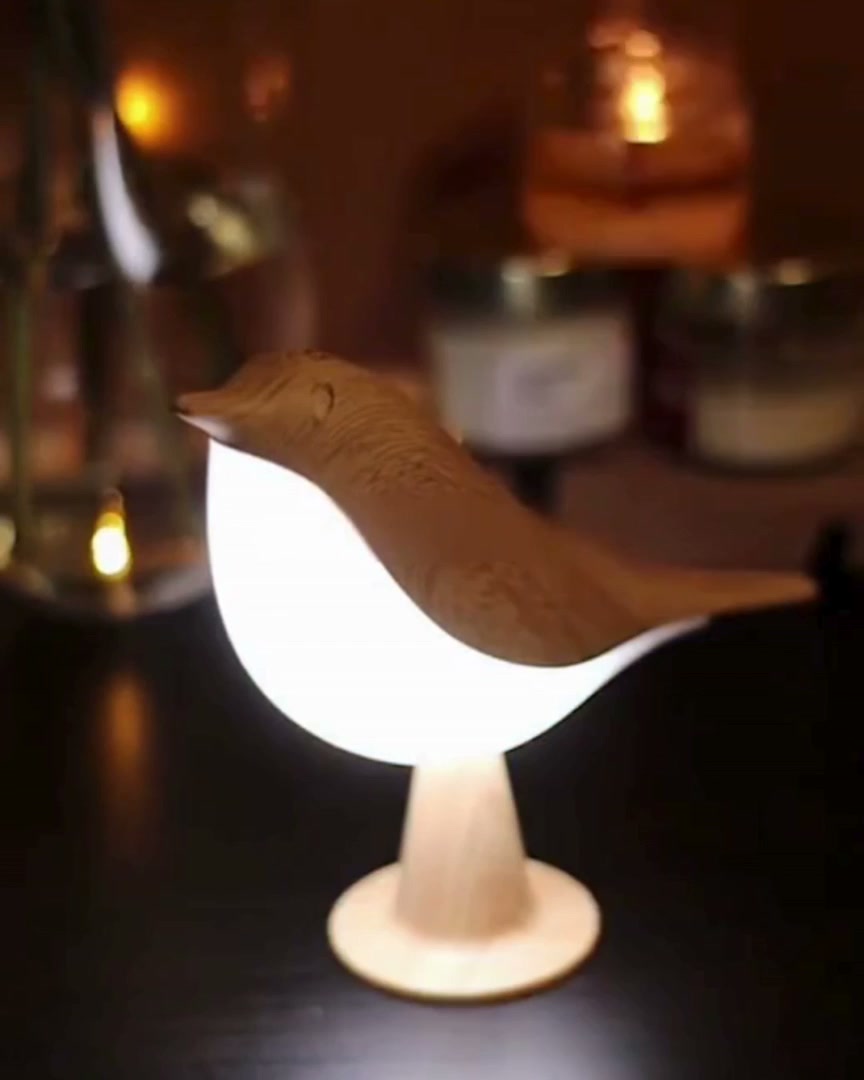 Bird lamp next to candles