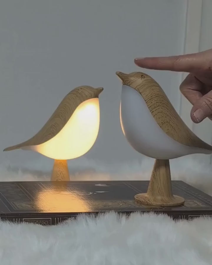 Two bird lamps glowing side by side